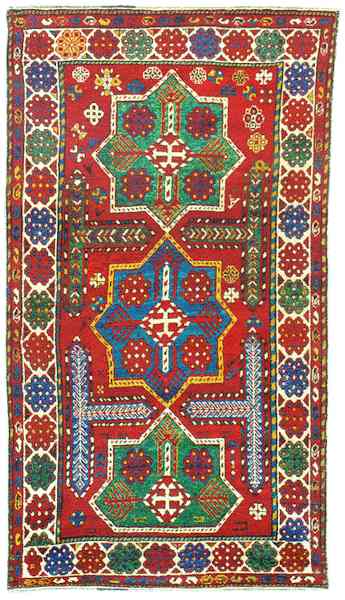 Akstafa Rugs: The Oliveira Three Medallion Akstafa RugOriental Rugs: A very beautiful Akstafa' rug with three large medallions. The medallions are typical Akstafa' large, squarish eight-pointed with the traditional cruciform interior design. This rug is unusual in many ways. There aren't many Akstafa' rugs without the traditional large birds on the field. This is one of those few. Also it is uncommon to find those T'-shaped motifs. The same is valid for the small cruciform hooked motif at the medallions' centre. But the most unlikely depiction is the profusion of Talish rosettes, so typical of Talish rug borders. We find it in this rug's borders and inside the medallions. This feature confirms Ian Bennett, Murray Eiland and Harold M. Keshishian's opinion that most of the denominated Akstafa' rugs were actually not woven on the large town in the Kazak weaving district (near Lambalo and Shulaver) but rather on the Shirvan weaving area, probably on south Shirvan. The magnificent colours of this rug also suggest a southern Shirvan attribution. 