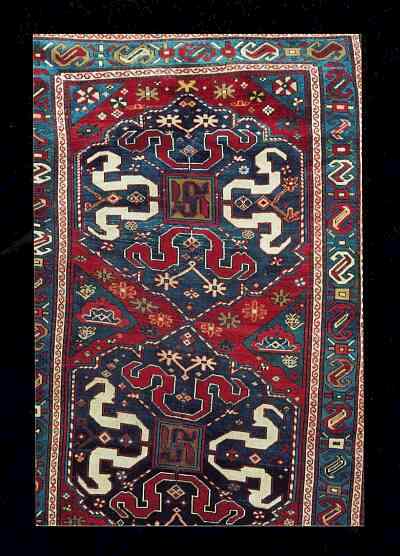 Oriental Rugs/Caucasian Rugs: Here is a CLASSICAL Cloud-Band Kazak, circa 1850-1870, Caucasus Mountains, measuring 48 X 109 inches. Cloudband Kazak's are revered among those who are deeply interested in Caucasian rugs. It may in fact be one of the most dynamic designs typical to ANY group of oriental rugs. The inspiration for the design is not that difficult to surmise. I believe the swirling bands floating upon the blue and green field of the octagons may be related to the ancient Central Asian symbol of the cloud-band. The cloud-band itself had celestial connotations for the ancient people of Central Asia, the center symbolizing the North Star around which the other stars appear to revolve. 